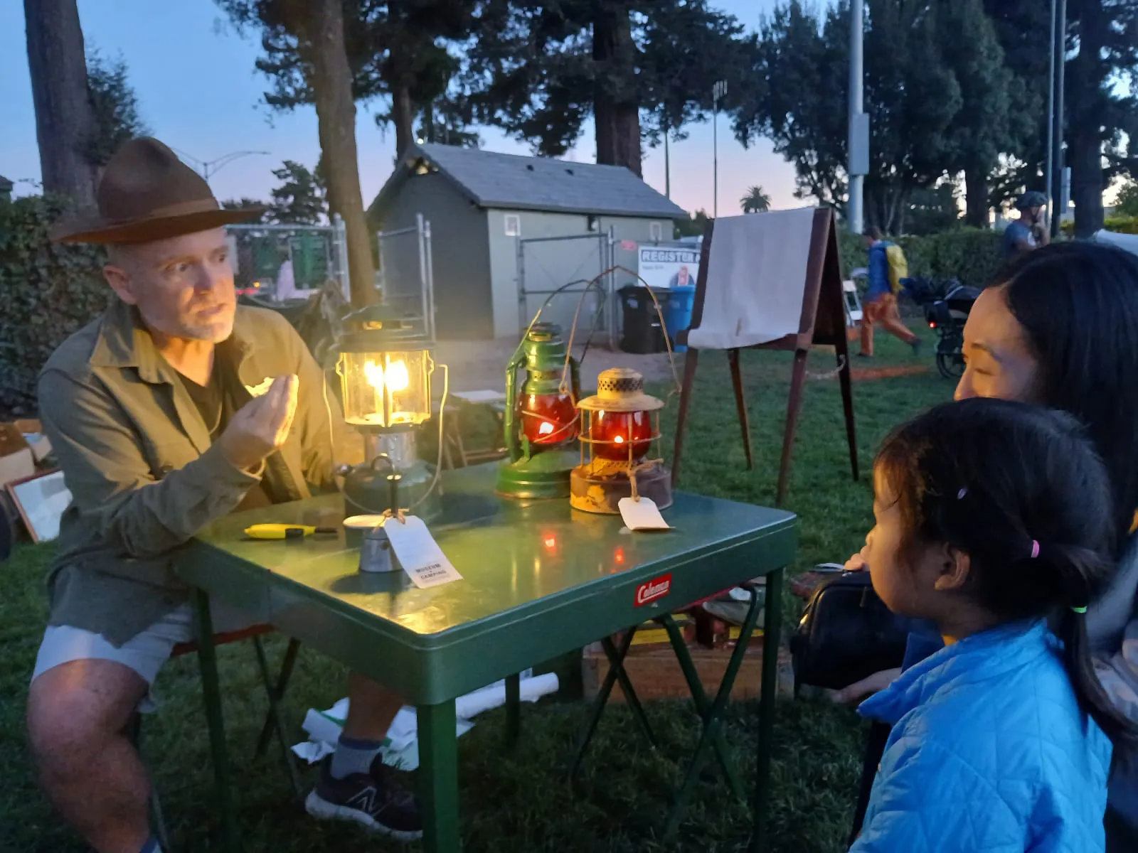 Founder Jeff Stanger explains the magic of the Coleman 220F double-mantle gas pressure lantern to a young Museum visitor and her parents