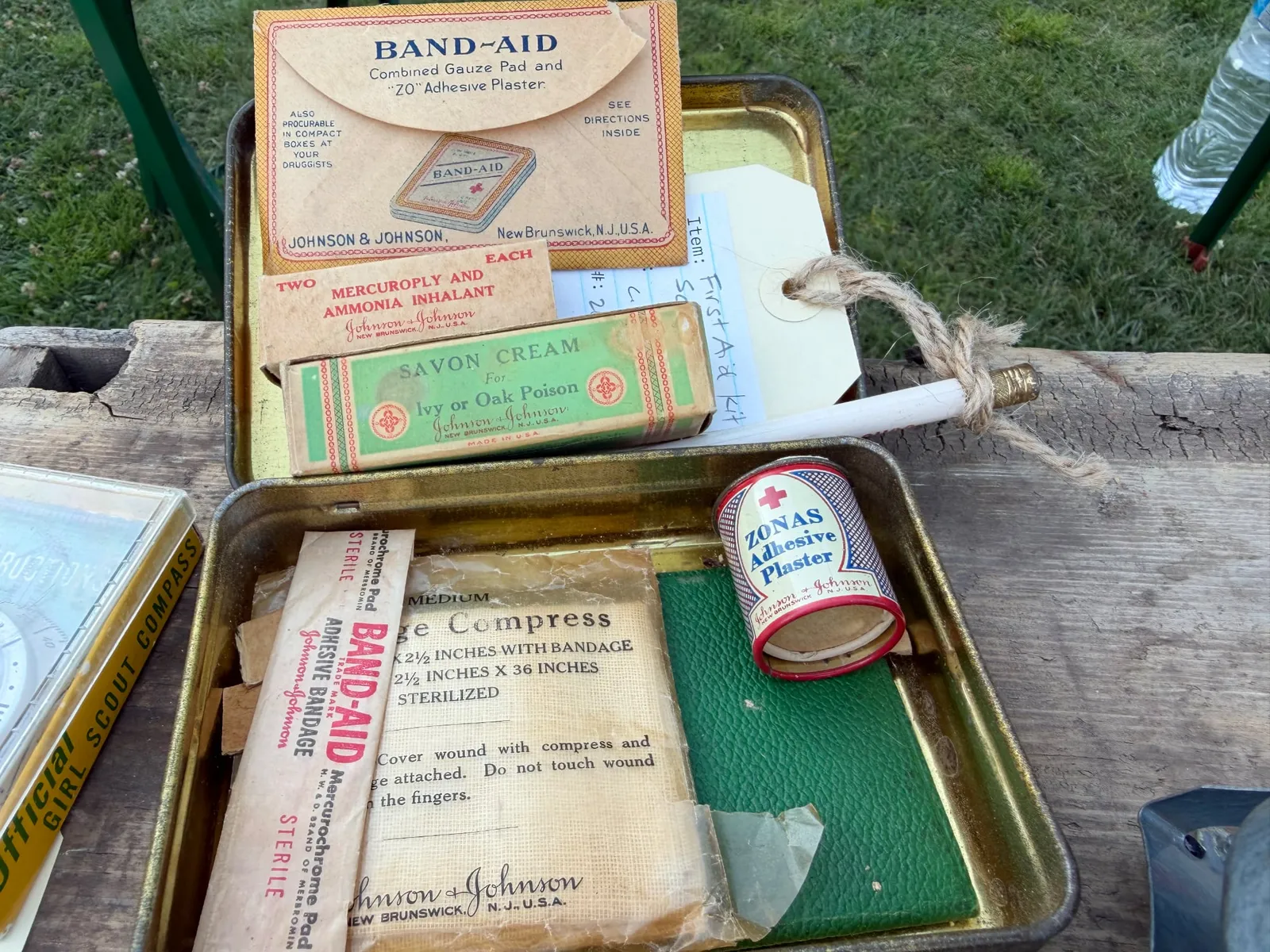 A 1930s official Girl Scouts of the United States of America first aid kit produced by Johnson & Johnson, including all of its original contents