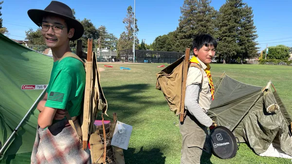 Scouts try on the first patented external frame pack system from the 1920s